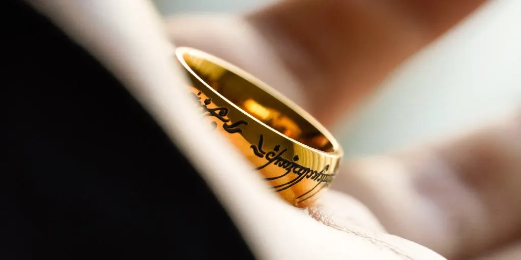 Frodo Baggins holding Lord of the Rings Golden Ring on hand